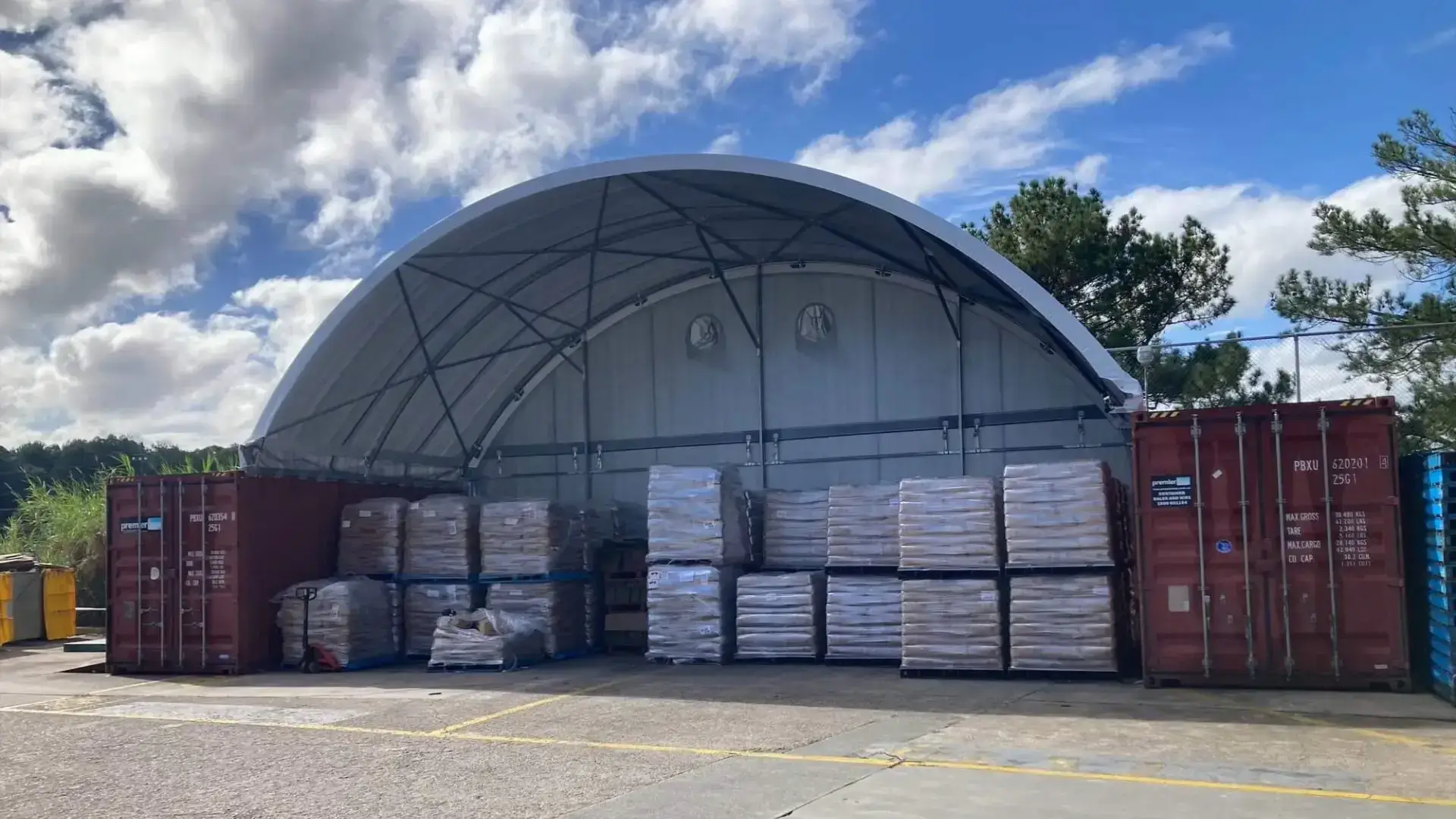 a container dome with two red shipping containers which is used for storagea container dome with two red shipping containers which is used for storage of pallets